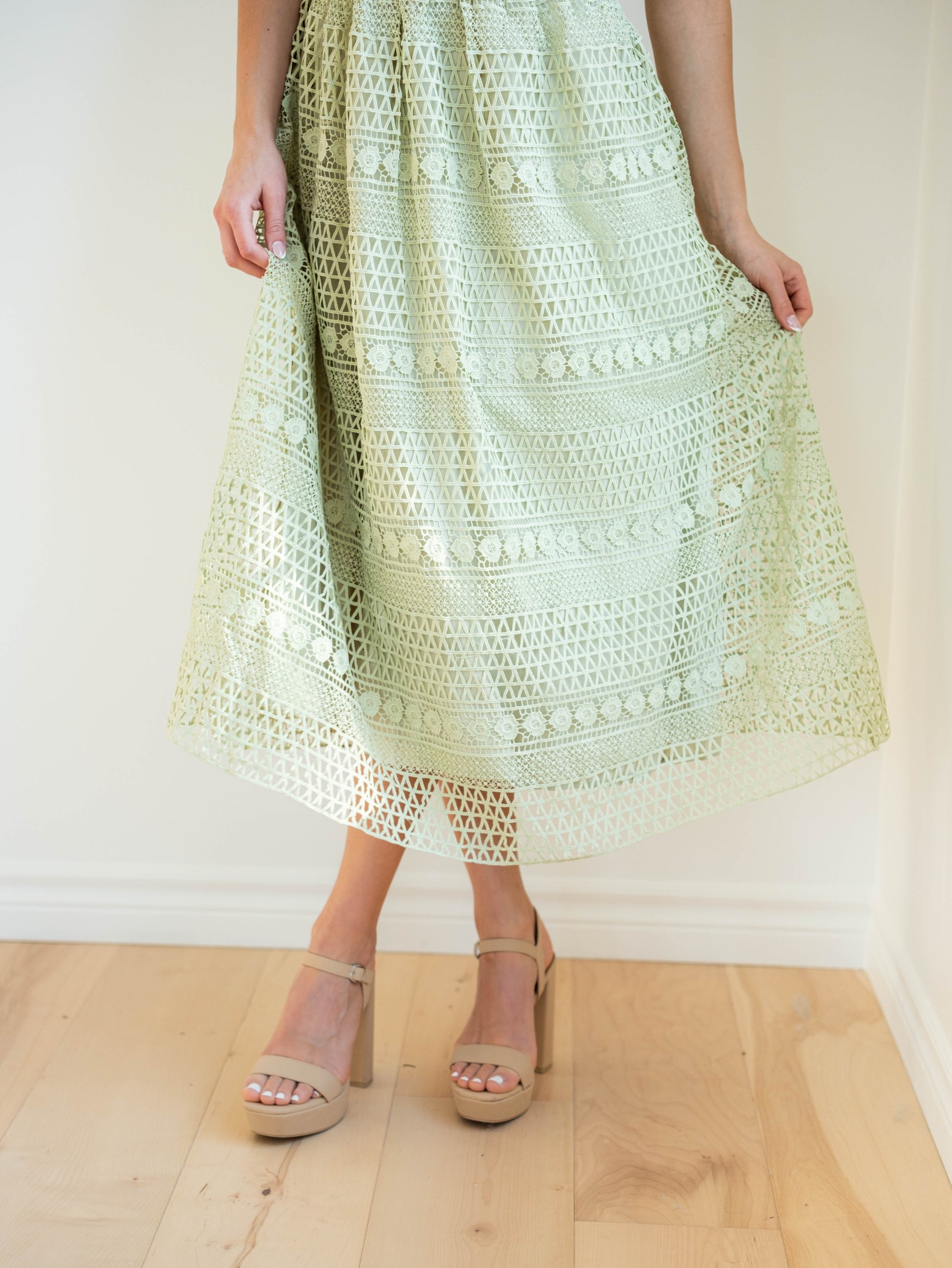 close up detail of bottom of dress, detailed crochet, sage green dress, flows beautifully